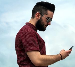 Man looking at cell phone.